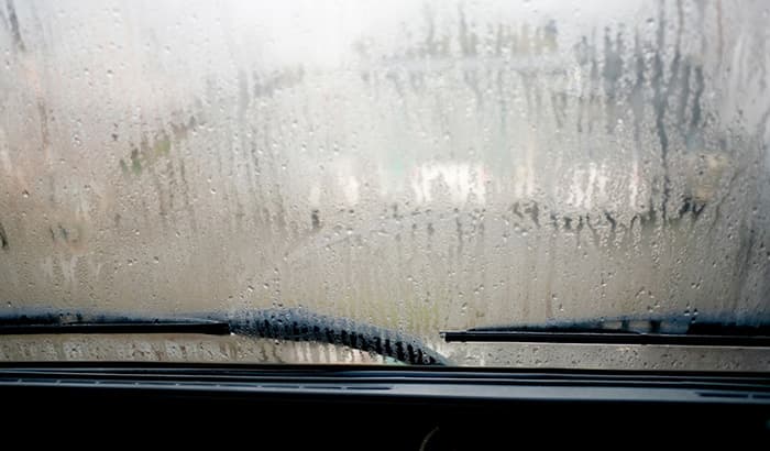 Water Droplets On Car Windshield Due To Condensation, Blurred View Through Windshield
