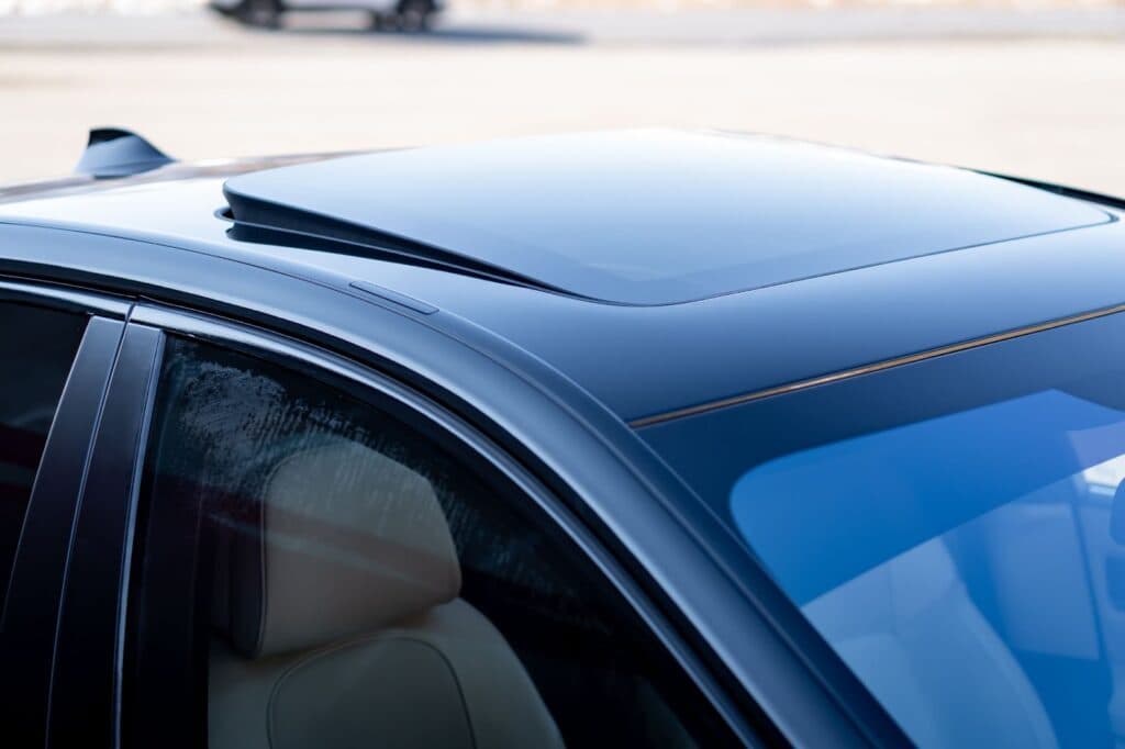 A car roof with an open sunroof.